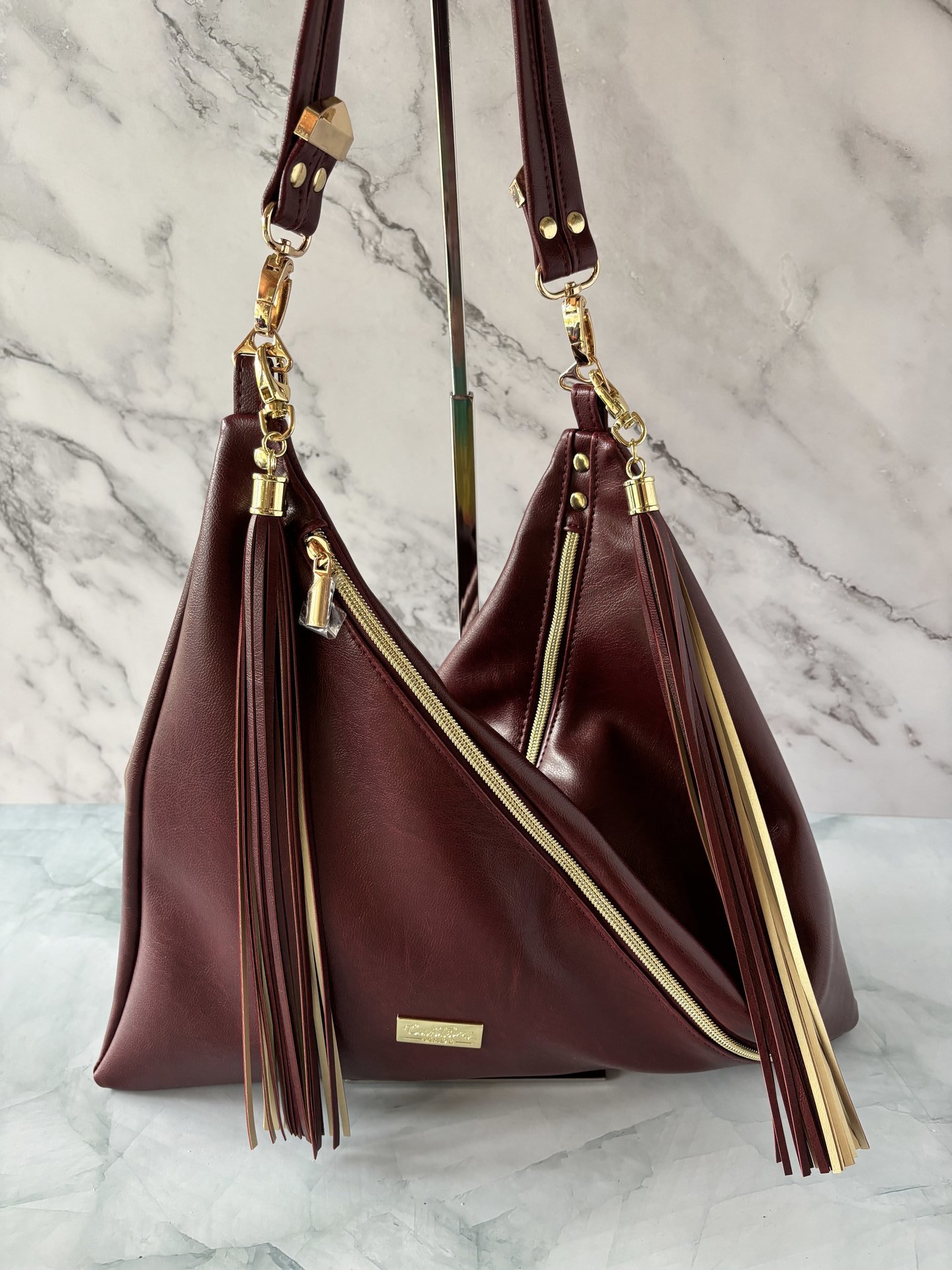 The Angler Slouchy Handbag - a rich, edgy, handbag with tassels + angled zipper giving it serious personality  - in a beautiful bordeaux faux leather